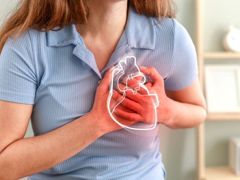 Woman in pain clutching her chest