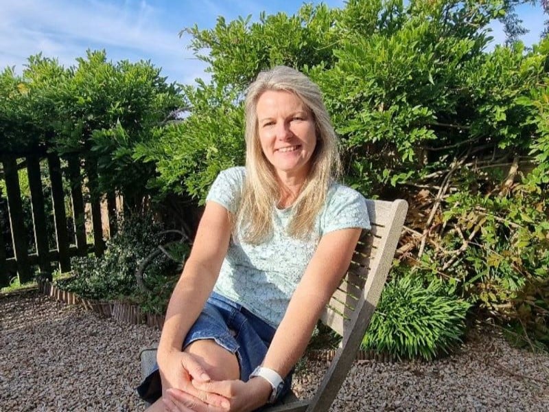 Sarah Hall sitting on a chair