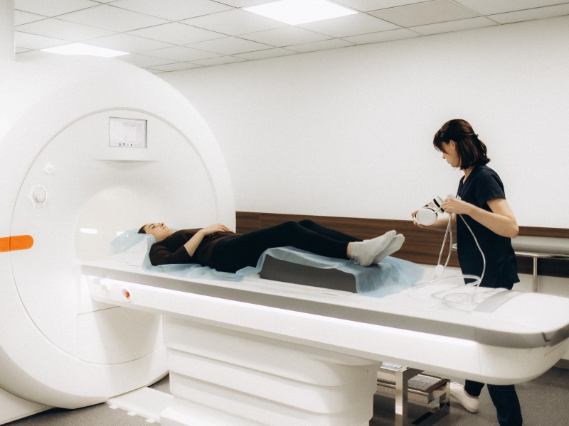 Photo of a patient and doctor preparing for an MRI scan