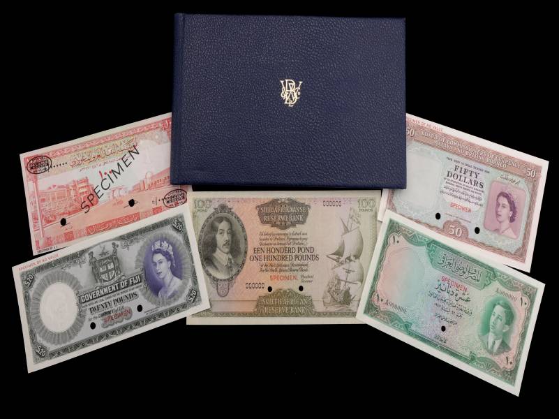 Selection of bank notes and an album on black background