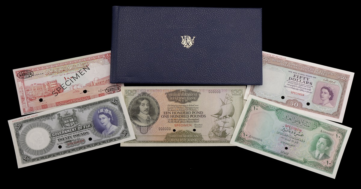 A selection of 5 rare bank notes and their folder against a black background