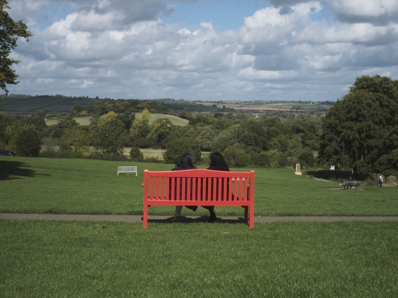 People on red bench in a park