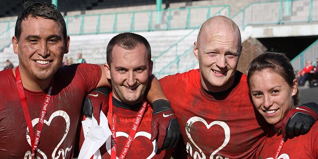Muddy British Heart Foundation runners with medals
