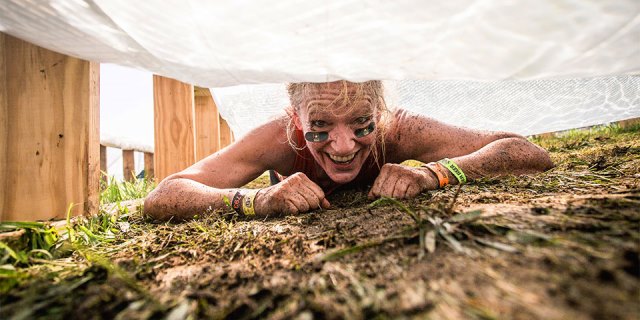 Tough Mudder runner crawling