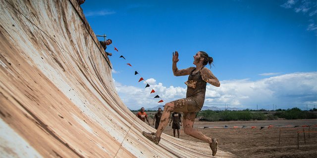 Tough Mudder Running running up obsticle
