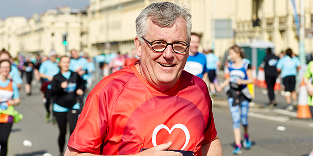 Smiling male runner in red BHF top