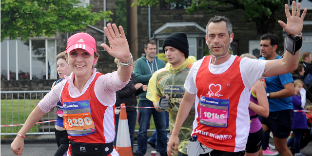 A couple give a smile and a wave on a BHF run.