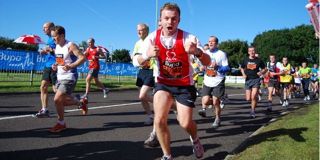 BHF Great Manchester Run for charity man in red vest smiling with thumbs up